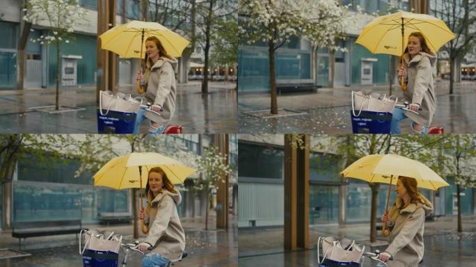 SLO MO年轻女子带黄伞在城市雨中骑自行车