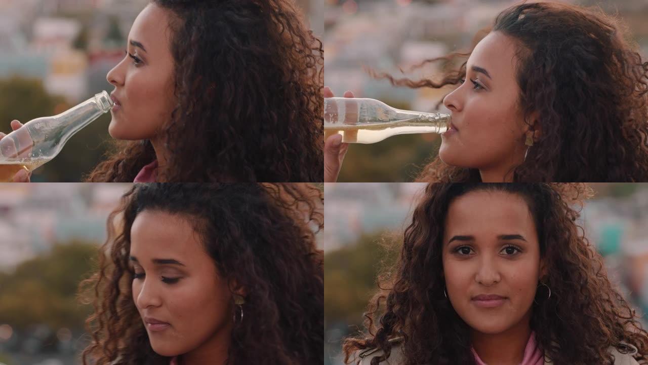 画像美丽的年轻的西班牙女子喝酒享受清凉的饮料放松在屋顶上的风吹头发
