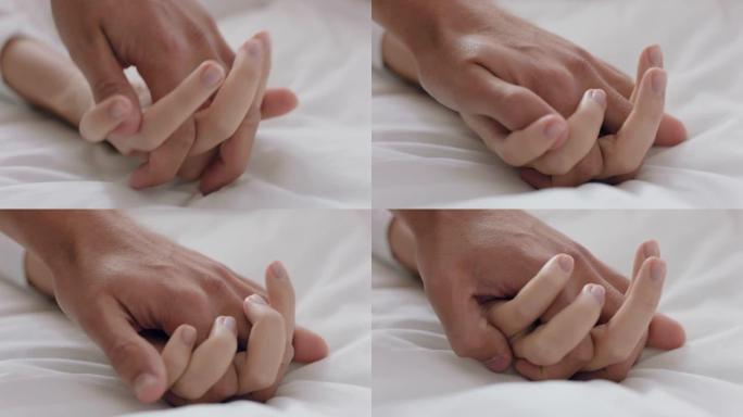 特写年轻夫妇手牵手躺在床上一起享受浪漫关系4k镜头