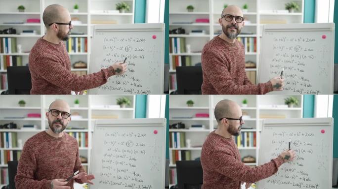 年轻的秃头老师在大学教室里用磁板教数学