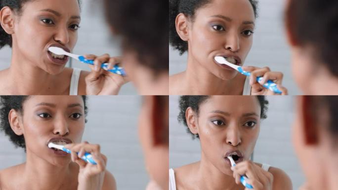 美女在浴室刷牙照镜子享受良好的口腔卫生准备早上例行公事