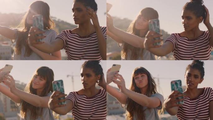 美丽的年轻女性朋友使用智能手机自拍，享受日落时在屋顶上闲逛，准备周末派对