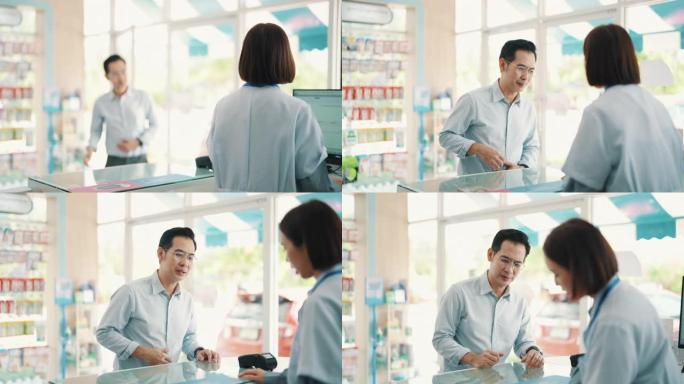 客户从药房的药剂师那里获得帮助。亚洲女药剂师帮助成熟的男性顾客提供药物推荐。小企业。药。健康概念