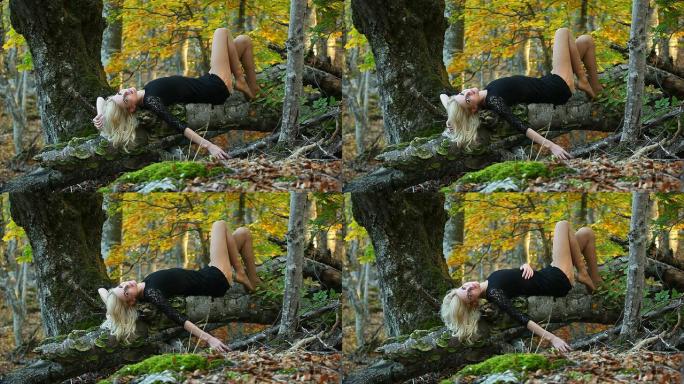 性感女人躺在倒下的树上