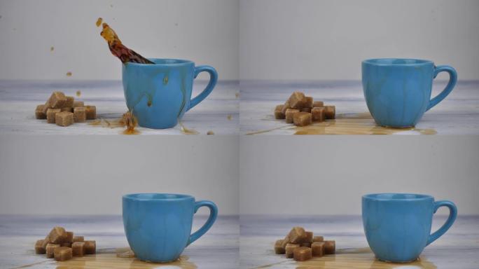 一立方红糖以慢动作，特写镜头落入白色木制背景上的红茶杯子中。早晨热能量饮料，红甜茶，早餐，配料概念