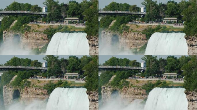 尼亚加拉瀑布 (Niagara Falls) 的强大水流，背景是游客步行的公园