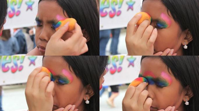 亚洲女孩得到彩虹脸画面具应用