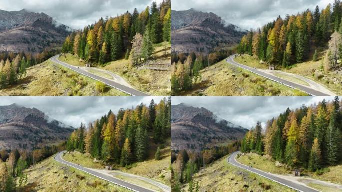 秋天在阿尔卑斯山的道路上骑自行车的两个人的鸟瞰图