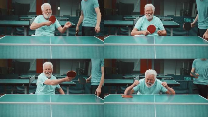 身患残疾的老人打双人乒乓球的静态镜头，期待胜利并得分。