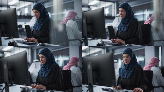 年轻的阿拉伯女性人工智能工程师在技术办公室从事计算机工作。年轻的中东专家为创新的大数据区块链项目编写
