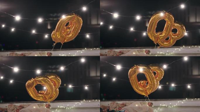 30岁生日派对金色气球晚上漂浮在屋顶上