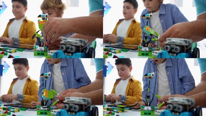机器人编程课。儿童构造和编码机器人。使用构造器块和笔记本电脑平板电脑、遥控操纵杆的STEM教育。面向