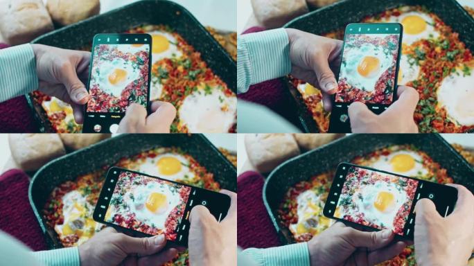 用手机给食物拍照。格鲁吉亚菜煎蛋，chirbuli。鸡蛋西红柿在锅里蒸，蜡烛效果