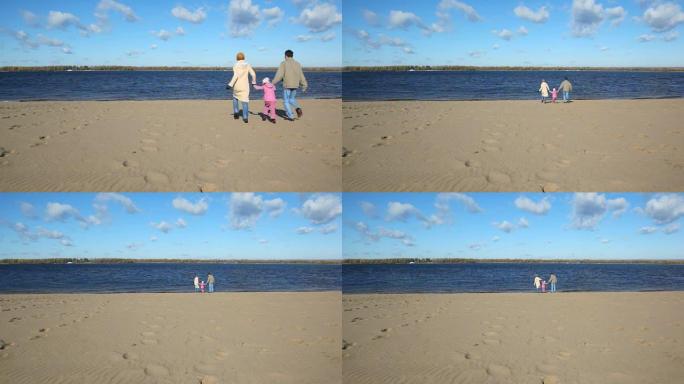 家庭在沙滩上奔跑