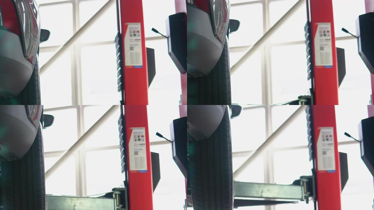服务升降机的特写视图。乘用车在汽车升降机上上升进行定期检查或年度维护
