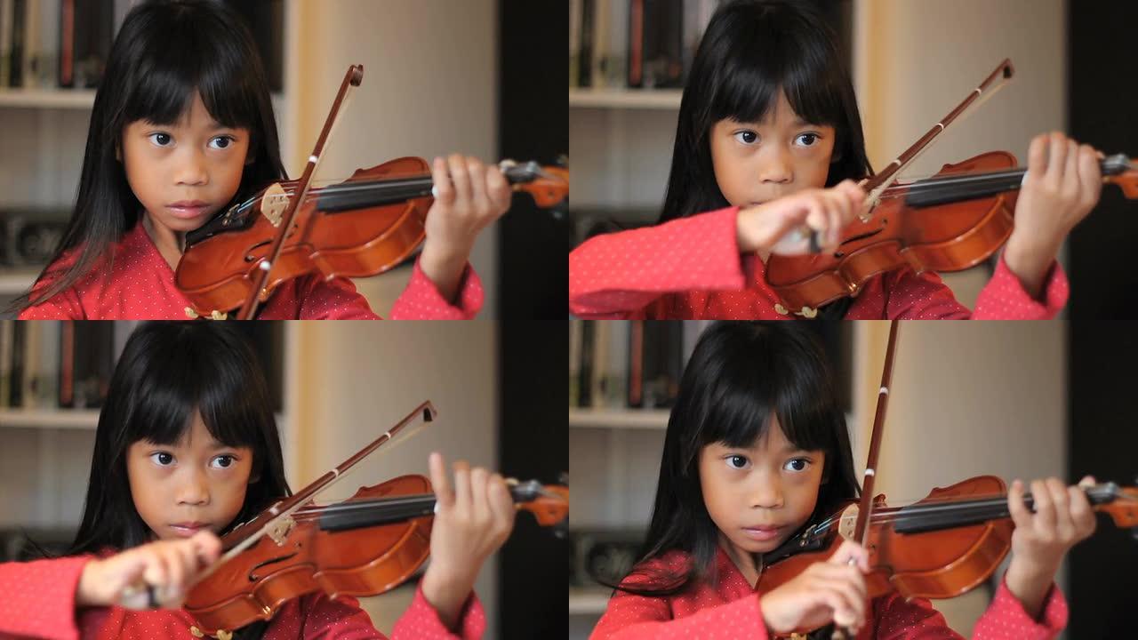 强烈的6岁亚洲女孩拉小提琴