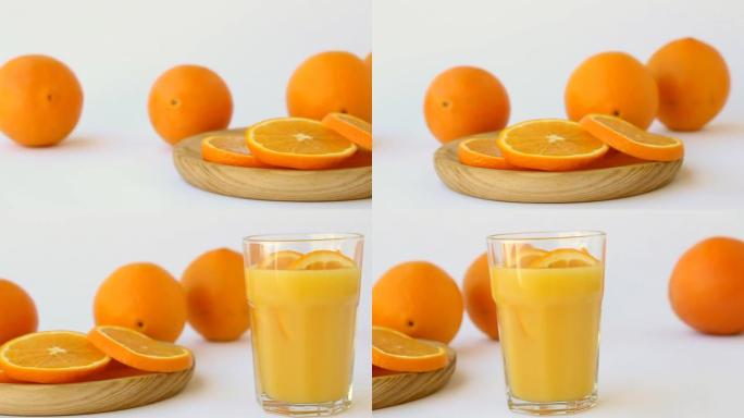 白色背景上的新鲜橙子和橙汁，多莉拍摄