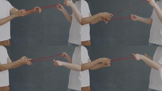 男人和女人用红绳绑住的手表达复杂的关系和非语言交流