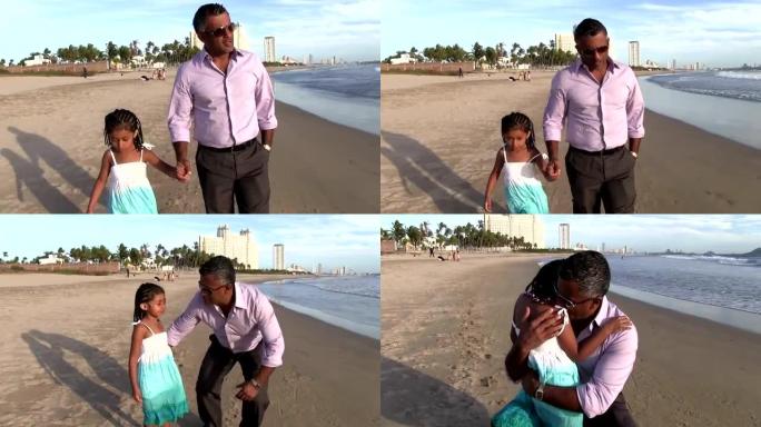 父亲和他的女儿在海滩上散步拥抱亲吻