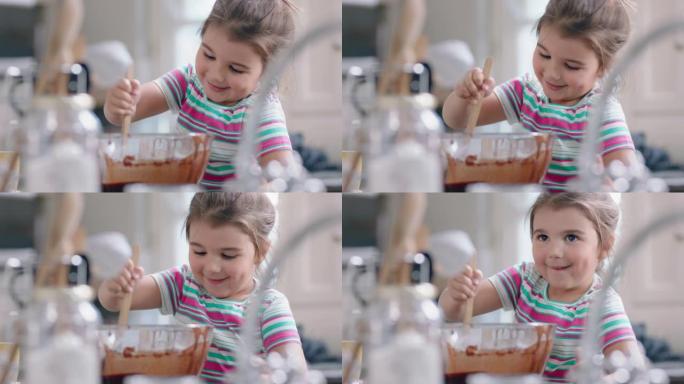 美丽的小女孩在厨房里烘烤自制巧克力纸杯蛋糕混合原料，有趣地准备美味佳肴