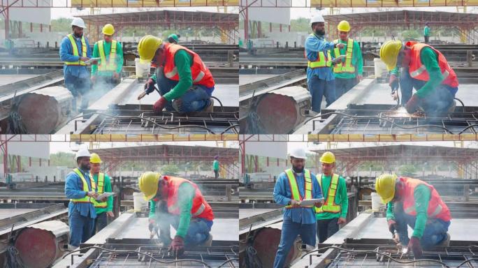 年轻的亚洲工人使用机器焊铁，手工作，主管在工业工厂检查，焊工或劳动焊接钢，经理检查，行业概念。
