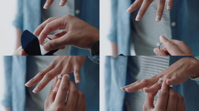 亲密的双手求婚年轻人向女友求婚，用美丽的钻石在她的手指上戴上结婚戒指，表达浪漫的承诺
