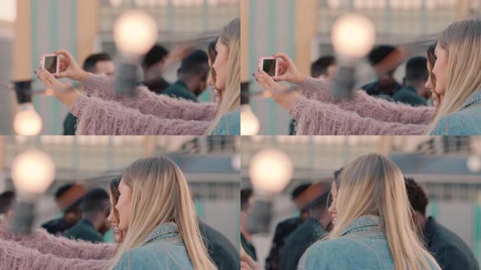 美丽的年轻女性朋友自拍照片使用智能手机享受屋顶派对在社交媒体上分享周末生活方式快乐庆祝友谊