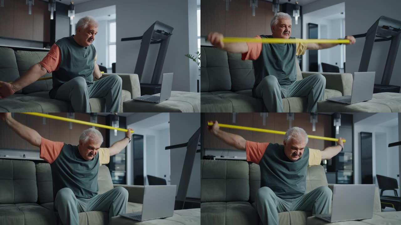 老年人的家庭健身，成熟的男人用棍子进行体育锻炼以促进脊柱健康