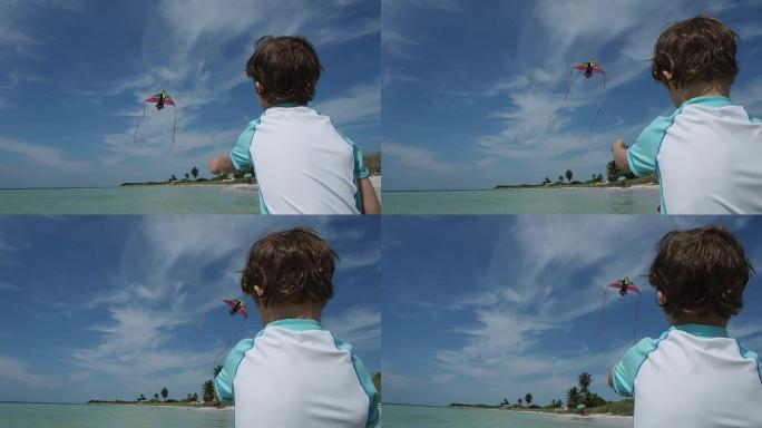 小男孩在海洋中放风筝