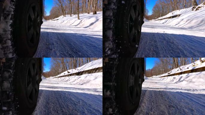 使用冬季轮胎在森林的积雪道路上行驶