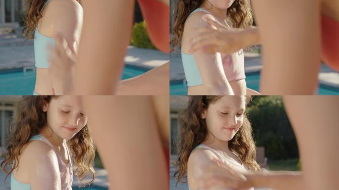 母亲在女儿皮肤上涂抹防晒乳液以保护阳光小女孩准备和妈妈一起在游泳池游泳，在阳光明媚的日子用防晒霜照顾