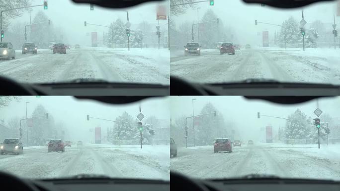 当驾驶员靠近十字路口时，正在下雪