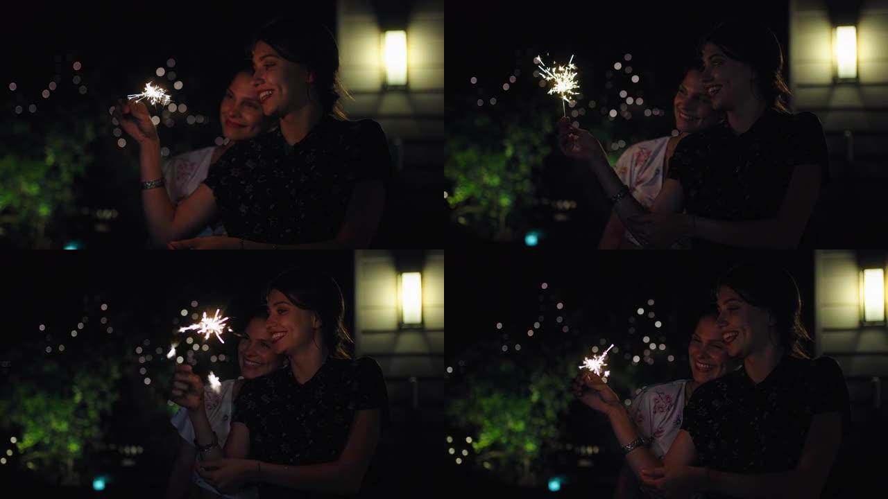 快乐的女孩朋友挥舞着火花一起庆祝新年前夜，在户外和平的夜晚享受节日庆祝4k镜头
