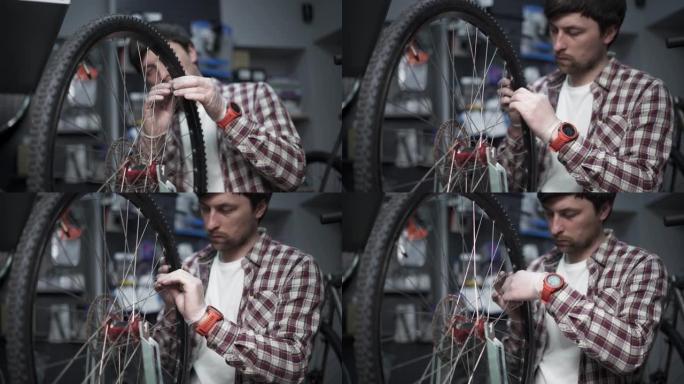 自行车车间的车轮矫直支架。机械师使用工具张紧速飞车边缘的辐条。小型企业自行车维修和服务主题。修整周期
