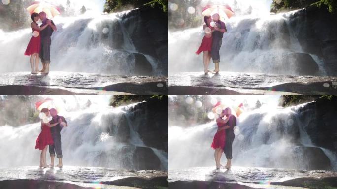 夫妇在瀑布边跳舞