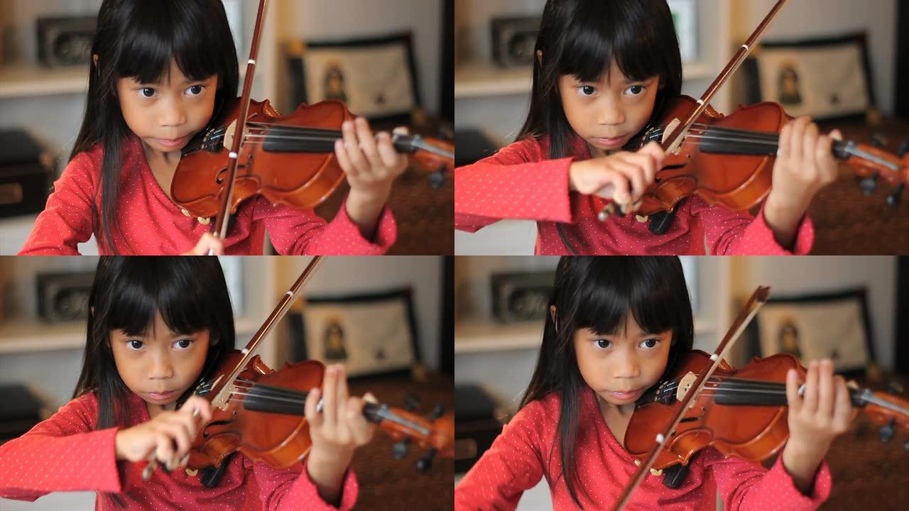亚洲女孩练习她的小提琴-高角度