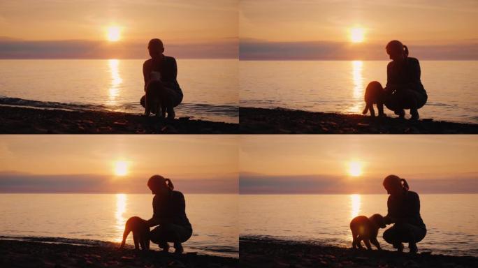 日落时在湖边与狗玩耍的女人