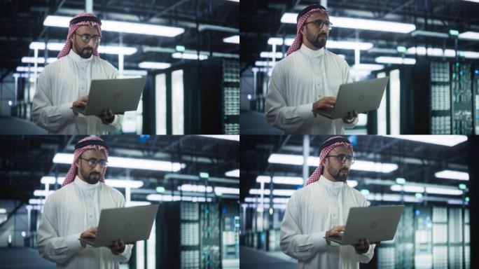 沙特系统管理员在数据中心的操作服务器机架行之间行走。工程师在网络安全和数据保护设施中使用笔记本电脑进
