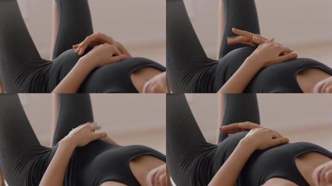瑜伽课上的年轻孕妇躺在健身垫上休息锻炼后享受健身工作室的健康生活方式