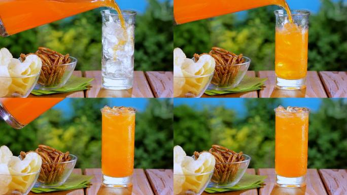 野餐时倒橙色苏打水