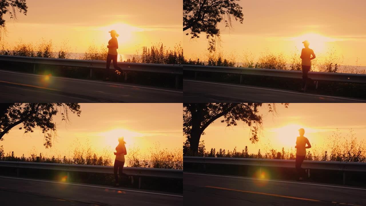日落时沿着海边的道路奔跑的女人的剪影。活跃的中年人