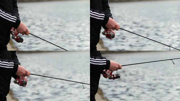 钓鱼旋转线圈、杆、手和水