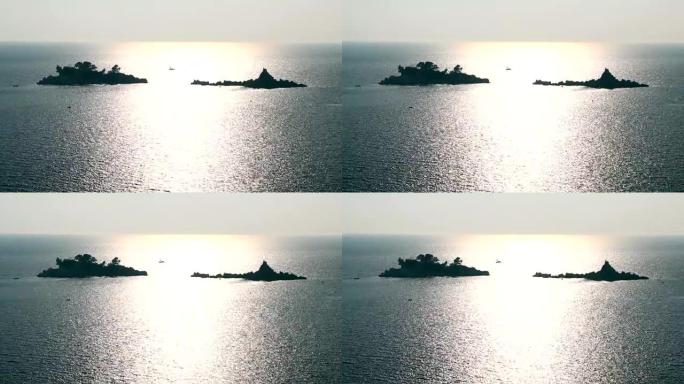 地平线上的帆船和岛屿