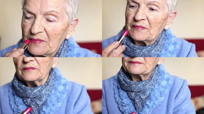 白发蓝眼睛的老年妇女用口红涂嘴唇