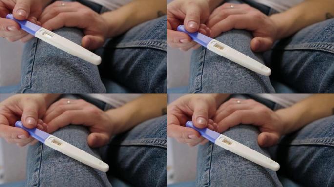 兴奋的已婚夫妇发现怀孕测试的结果。