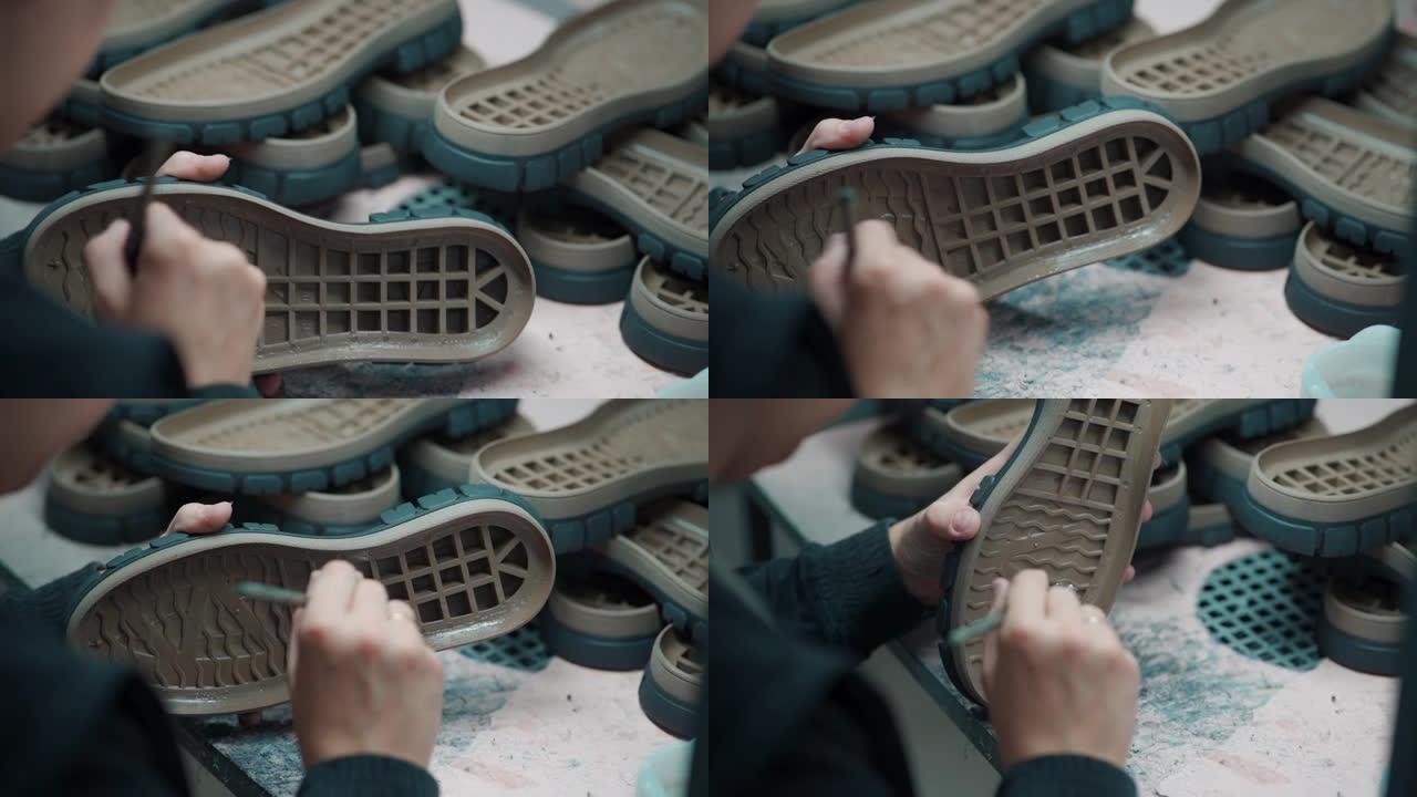 在鞋类生产中，工人在鞋上的手胶鞋底