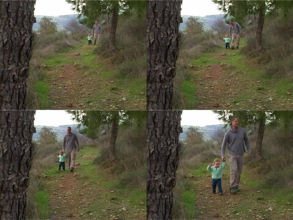 爸爸和女孩走在森林上