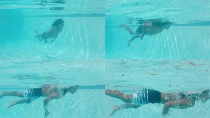 快乐的小男孩在游泳池水下游泳，享受夏日4k在清澈的水中游泳