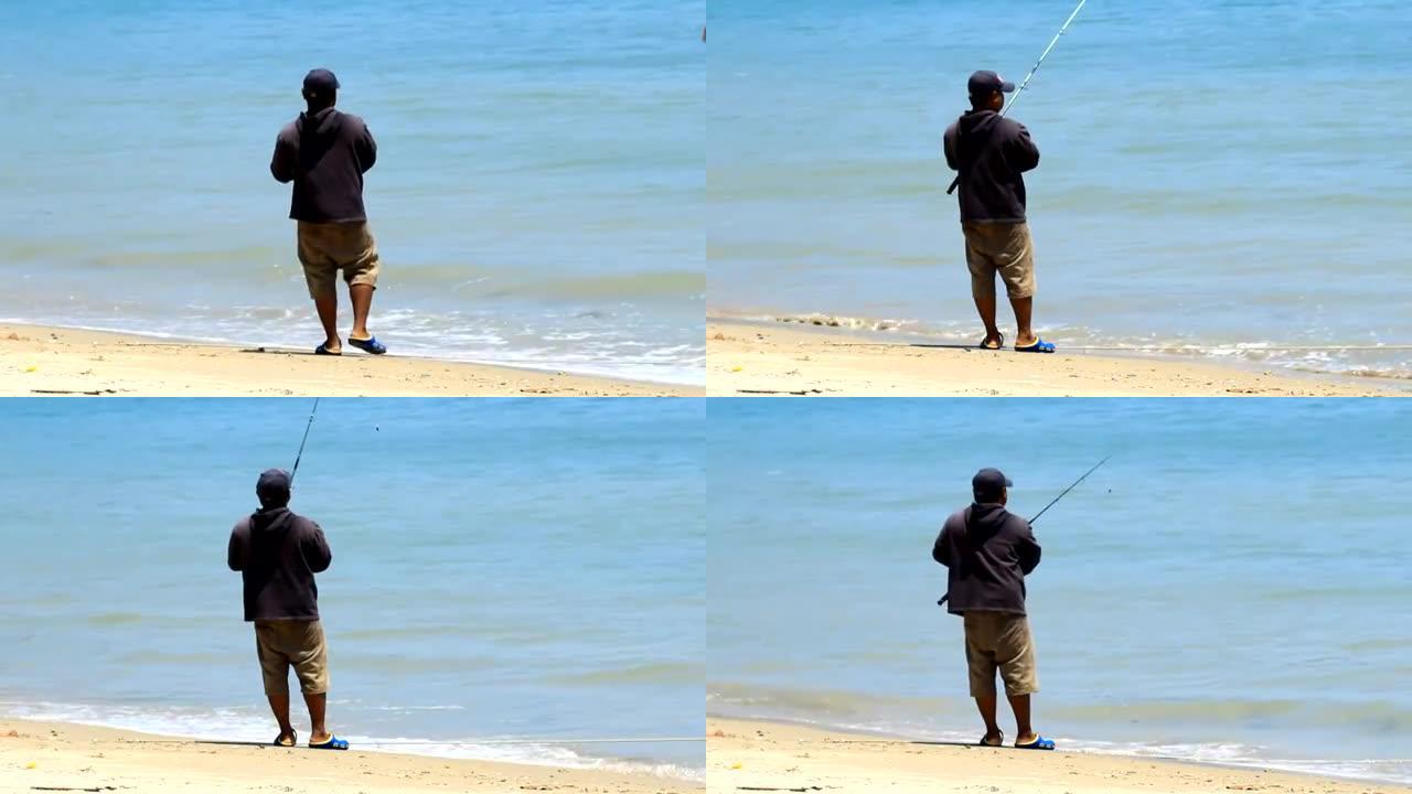 一个从海滩钓鱼的人