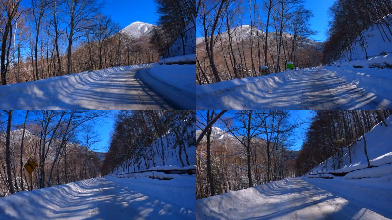 在冬季山区积雪覆盖的道路上行驶